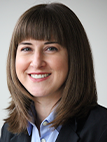 Professional woman with straight brown hair smiling.