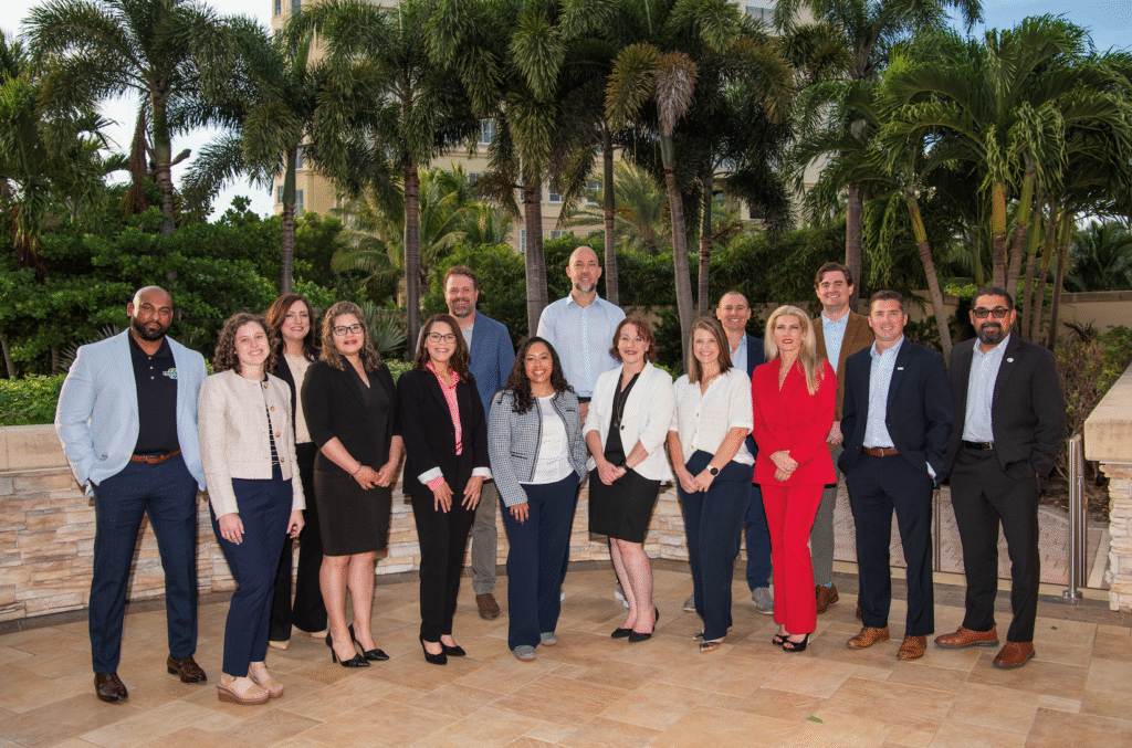 Two men smiling and posing for a photo indoors.